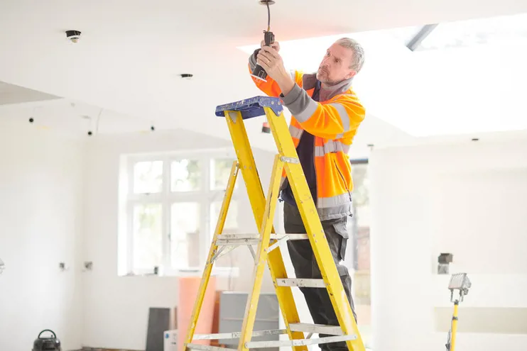 Man On Ladder Fixing Downlight